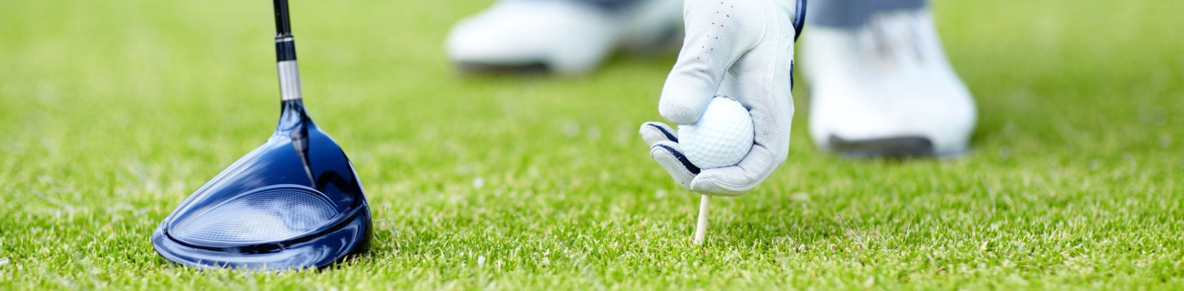 Golfer teeing up a golf ball