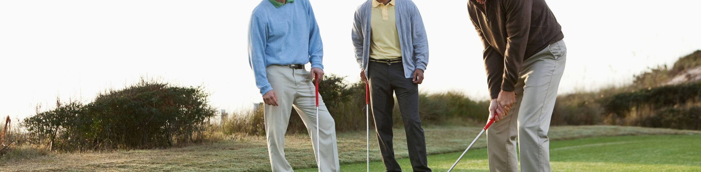 3 golfers playing golf