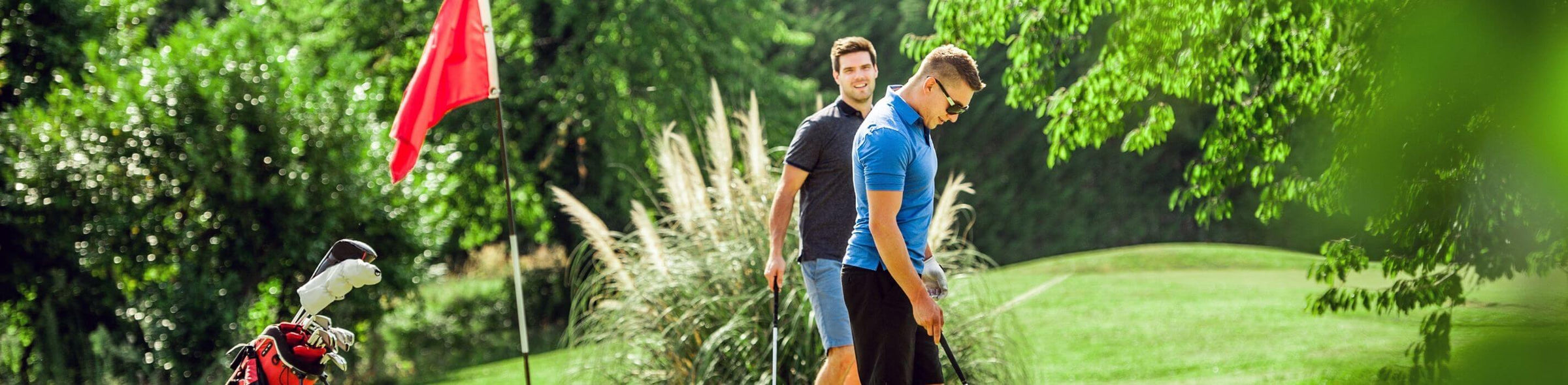 Two golfers walking the green